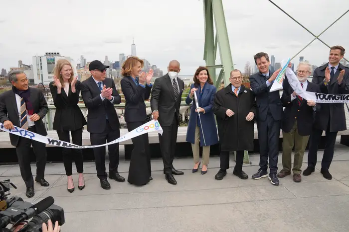 Officials line up to cut the ceremonial ribbon for the brand new rooftop park at Hudson River Park's Pier 57.